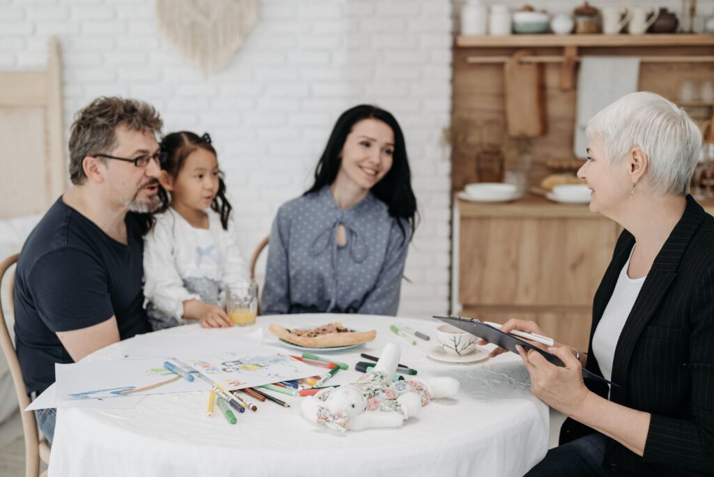 pexels-photo-8205410-8205410 Adoptive family discussing with a social worker indoors, creating a warm, welcoming atmosphere.