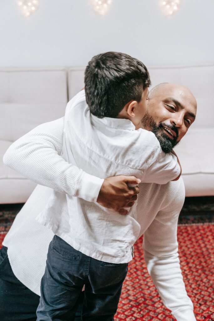 pexels-photo-9127113-9127113 Heartwarming moment of father hugging son indoors, showcasing family love and connection.
